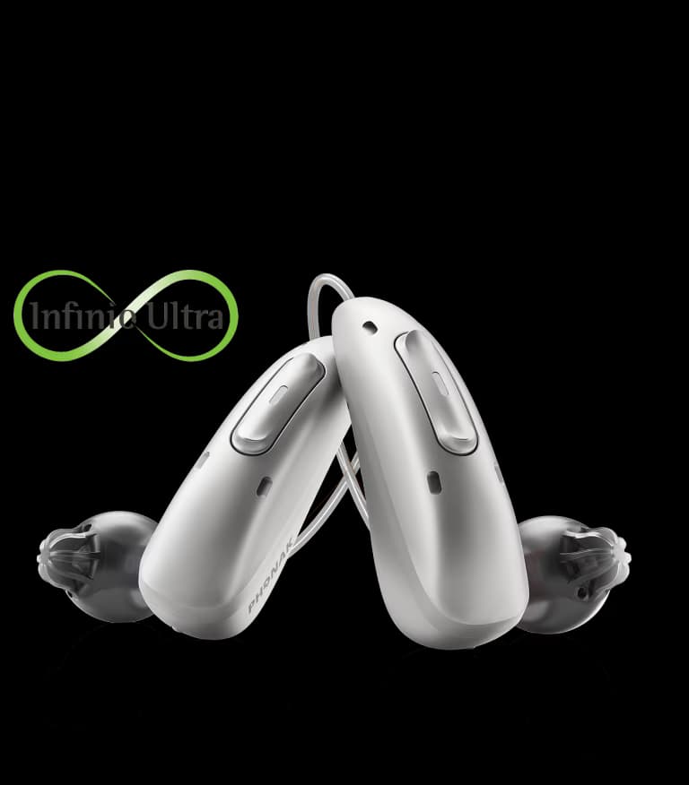 A pair of Phonak Audéo Infinio hearing aids with dome receivers and the Infinio Ultra mark