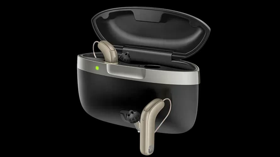 Widex SmartRIC hearing aid resting in its charging case